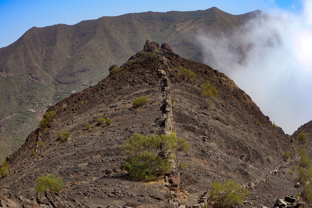 Hiking trail and clouds at the ridge of Los Carrizales