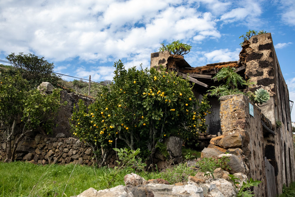 Alte Steinhäuser und Obstgärten am Wegesrand
