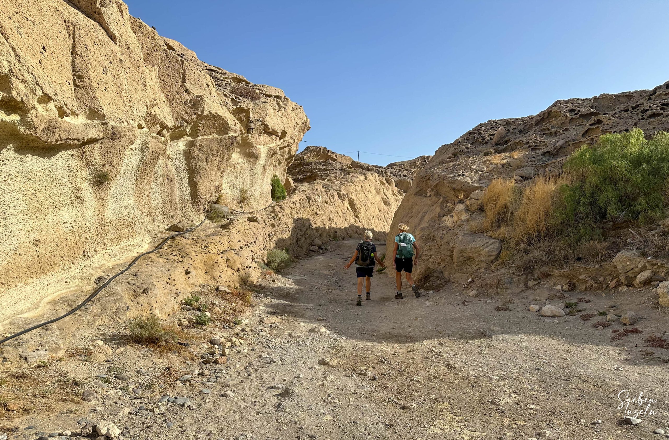 Hiking trail near the coast between sandstone and rocks