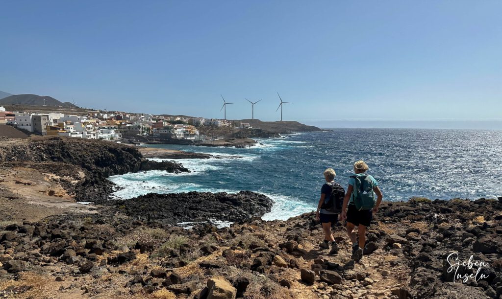 Hikers on the coastal trail with a view of La Jaca